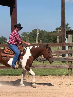 man riding horse at restoration ranch